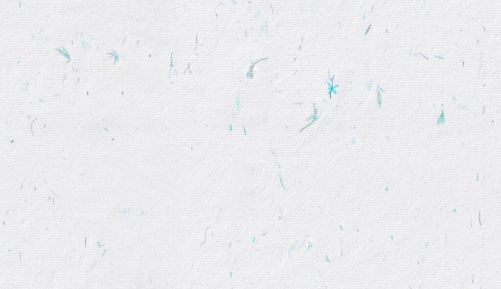 Gemini 2.5 Pro - White textured background with subtle blue speckles.